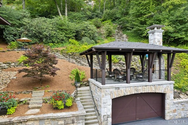 view of patio featuring a garage and a gazebo