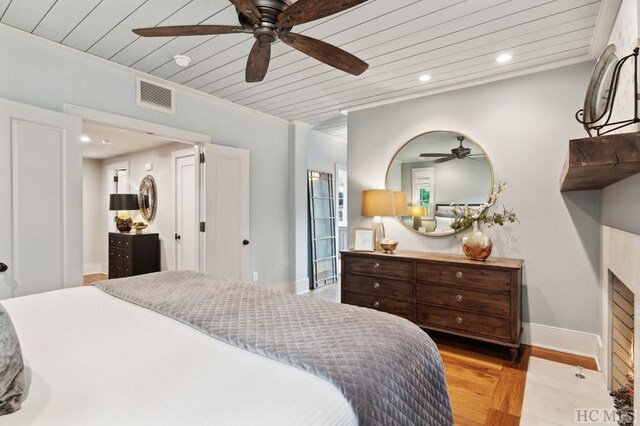 bedroom with wooden ceiling, light hardwood / wood-style floors, and ceiling fan