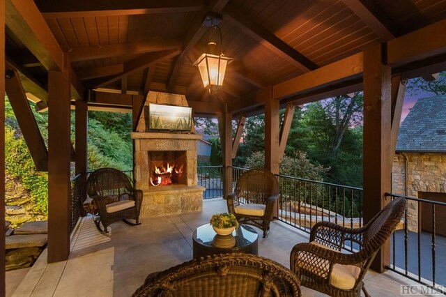 view of patio / terrace featuring a gazebo and an outdoor stone fireplace