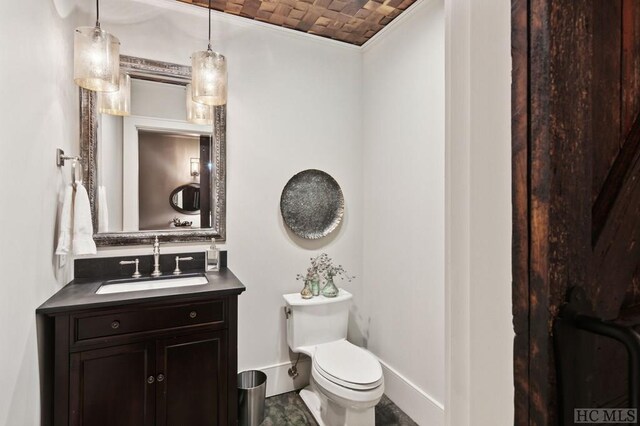 bathroom featuring brick ceiling, vaulted ceiling, vanity, and toilet