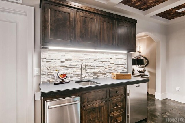 bar with stainless steel appliances, brick ceiling, dark brown cabinets, and sink