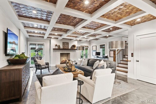 living room featuring beamed ceiling, concrete flooring, and coffered ceiling