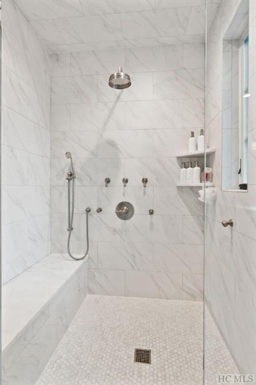 bathroom with tiled shower