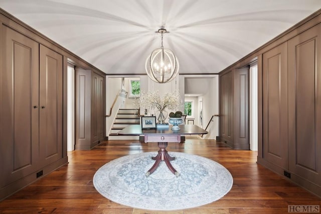 interior space with dark hardwood / wood-style floors and a notable chandelier