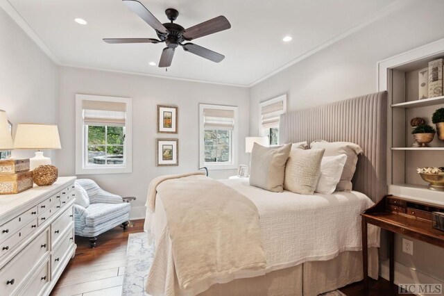 bedroom featuring crown molding, ceiling fan, and dark hardwood / wood-style flooring