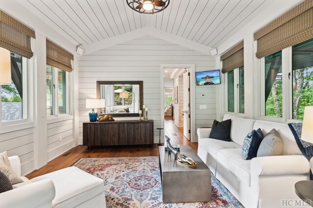 sunroom / solarium featuring lofted ceiling, radiator heating unit, and wooden ceiling