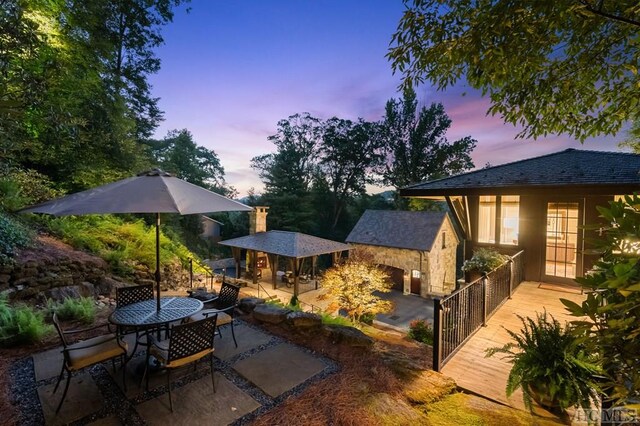 patio terrace at dusk with a wooden deck