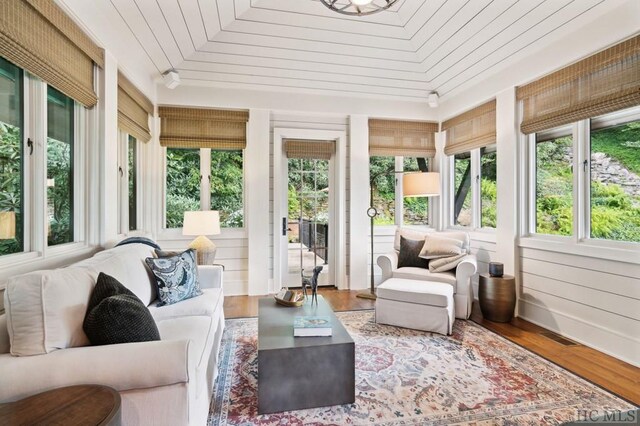 sunroom / solarium featuring wood ceiling