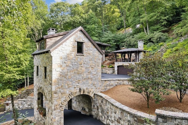 view of side of property featuring a gazebo