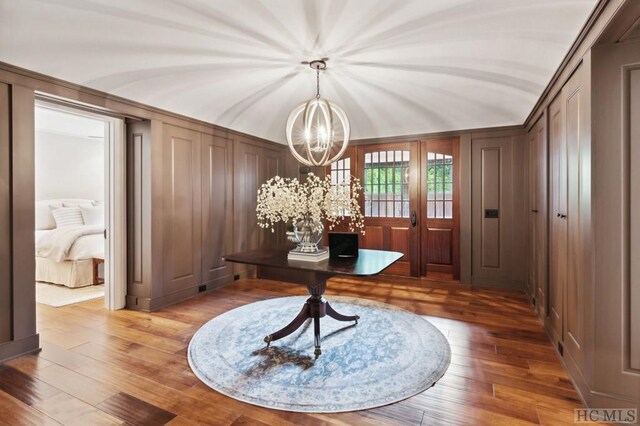 office area featuring hardwood / wood-style floors and an inviting chandelier