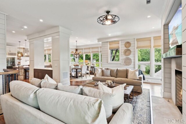 living room featuring a notable chandelier and light wood-type flooring