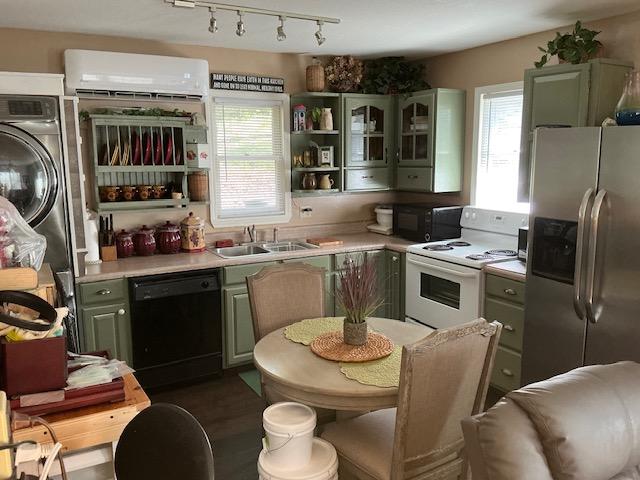 kitchen featuring black appliances, a sink, open shelves, a wall unit AC, and light countertops