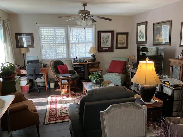 living room featuring a desk, a ceiling fan, and wood finished floors