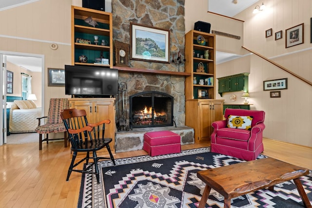145 Mount Lori Dr, Highlands, NC 28741 - living room with light wood-type flooring, a stone fireplace, and a decorative wall