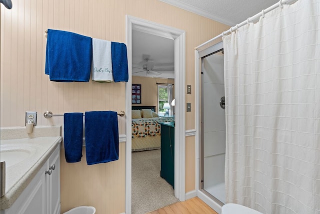 145 Mount Lori Dr, Highlands, NC 28741 - bathroom with connected bathroom, a stall shower, a ceiling fan, crown molding, and wood finished floors