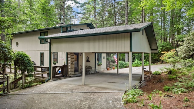 145 Mount Lori Dr, Highlands, NC 28741 - view of front of home featuring concrete driveway, roof with shingles, and an attached carport