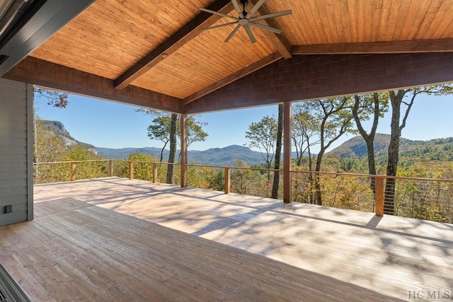 deck featuring a mountain view and ceiling fan