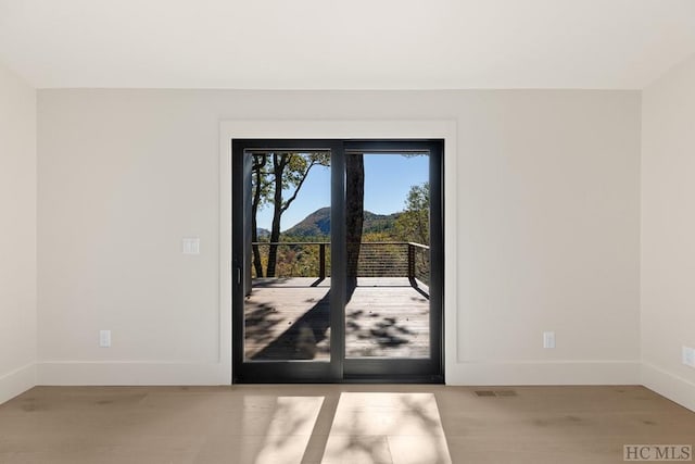 doorway to outside with light wood-type flooring