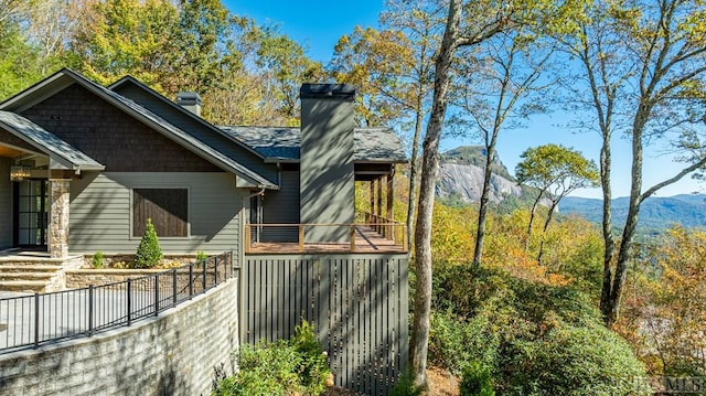 view of home's exterior with a mountain view and a balcony