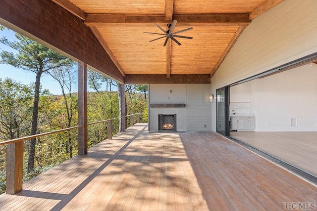 exterior space with ceiling fan and an outdoor fireplace