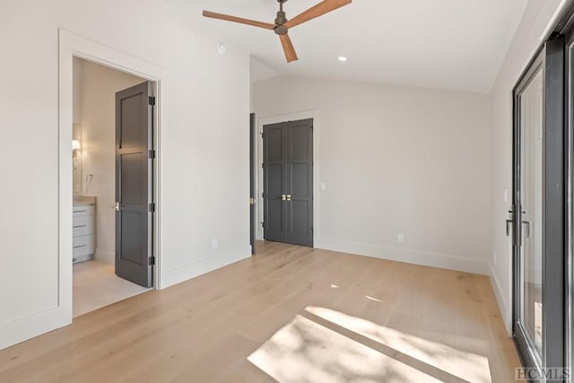 unfurnished bedroom with vaulted ceiling, ensuite bathroom, ceiling fan, and light hardwood / wood-style floors