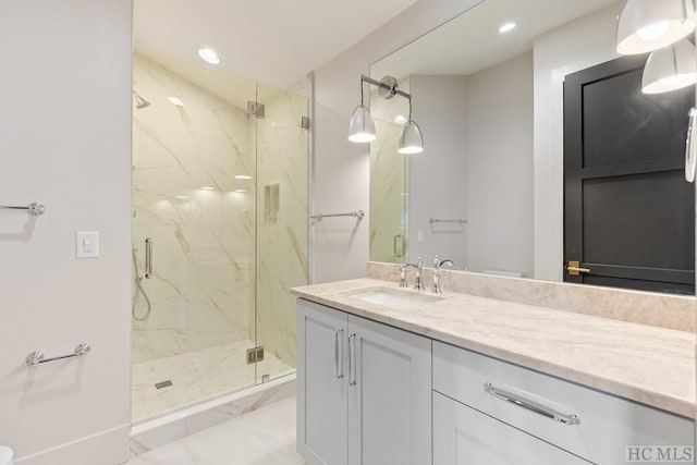 bathroom with vanity and an enclosed shower