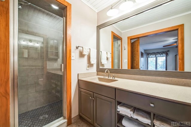 bathroom with crown molding, a shower with shower door, and vanity