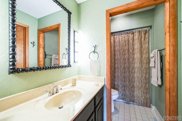 bathroom featuring vanity, toilet, curtained shower, and tile patterned flooring