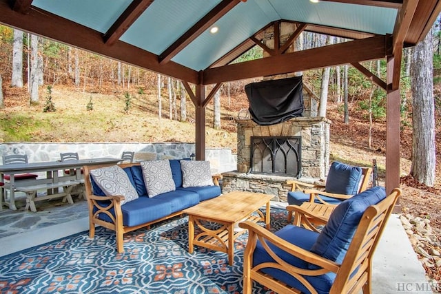 view of patio / terrace with a gazebo and an outdoor living space with a fireplace