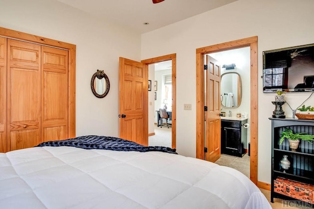 bedroom featuring connected bathroom, light colored carpet, and a closet