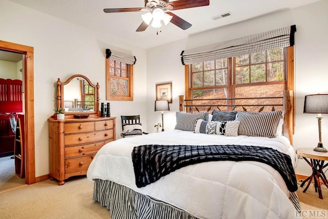 bedroom featuring light carpet and ceiling fan