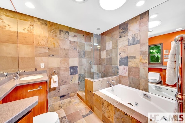43 Chimney Pt, Lake Toxaway, NC 28747 - full bathroom with tile walls, a jetted tub, a shower stall, vanity, and recessed lighting
