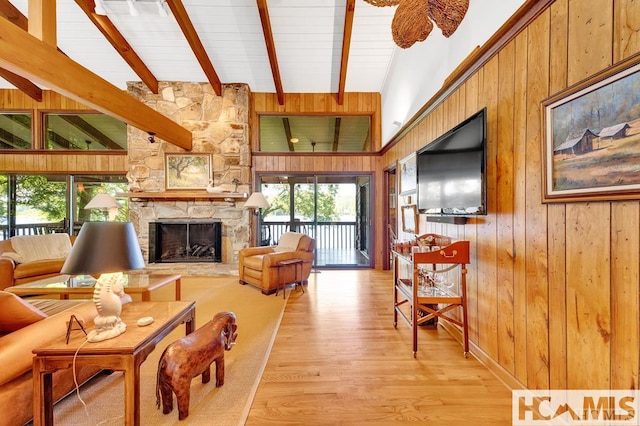 43 Chimney Pt, Lake Toxaway, NC 28747 - living area featuring light wood-type flooring, beam ceiling, a fireplace, and wood walls