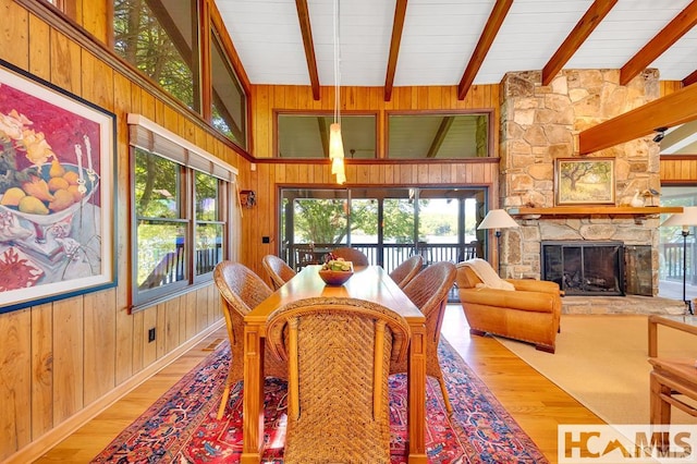 43 Chimney Pt, Lake Toxaway, NC 28747 - dining area featuring wood finished floors, wood walls, beam ceiling, and a fireplace