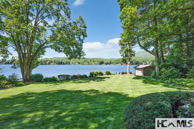 43 Chimney Pt, Lake Toxaway, NC 28747 - view of green lawn with a water view and an outdoor structure