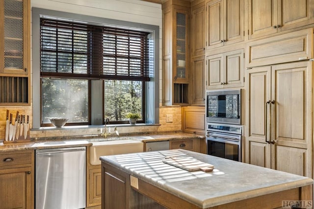 kitchen with tasteful backsplash, built in appliances, a center island, and sink