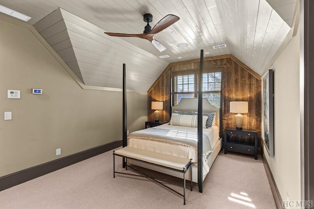 bedroom with wood ceiling, vaulted ceiling, ceiling fan, wooden walls, and light colored carpet