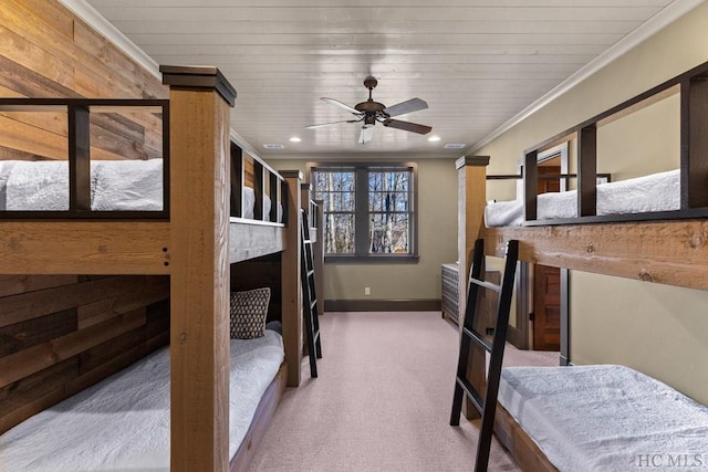 carpeted bedroom featuring ornamental molding, wooden ceiling, and a fireplace