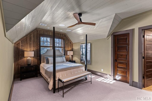 carpeted bedroom featuring wooden walls, wooden ceiling, ceiling fan, and vaulted ceiling