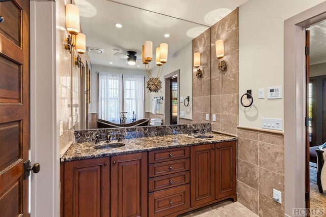 bathroom with vanity, tile walls, and ceiling fan