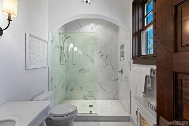 bathroom with tiled shower and toilet