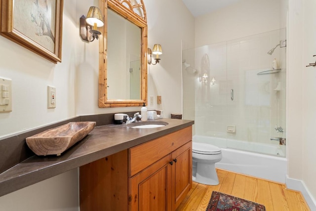 bathroom with vanity, bathing tub / shower combination, toilet, and wood finished floors