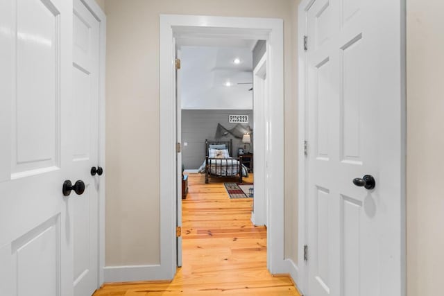 hallway with light wood-style flooring and baseboards