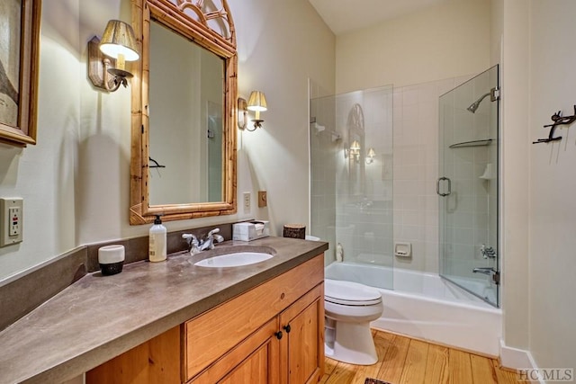 full bathroom with bathing tub / shower combination, toilet, wood finished floors, and vanity