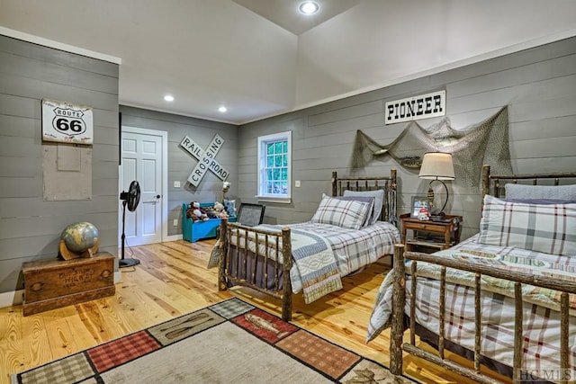 bedroom with recessed lighting and wood finished floors