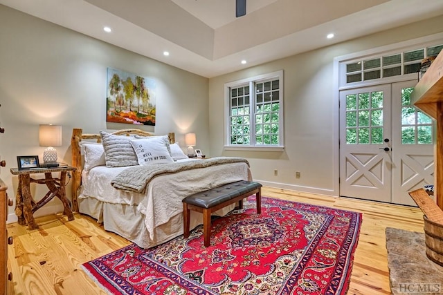 bedroom with access to exterior, recessed lighting, and light wood finished floors