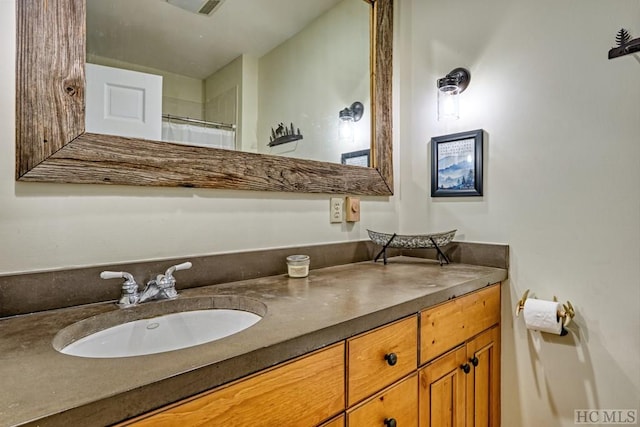 bathroom featuring vanity and a shower with shower curtain