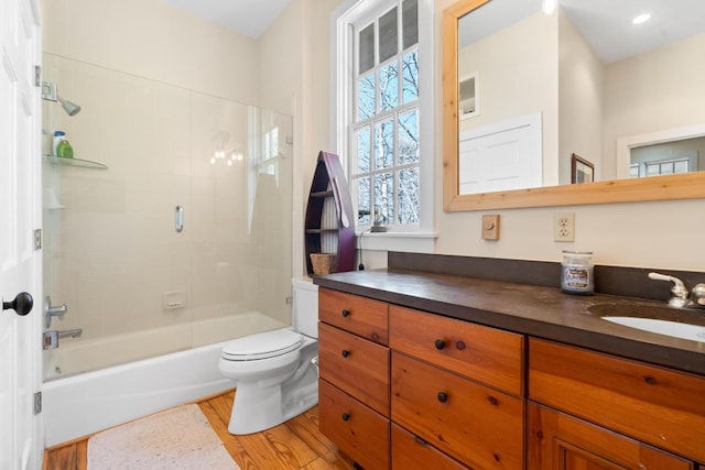 full bathroom with bathtub / shower combination, toilet, wood finished floors, and vanity