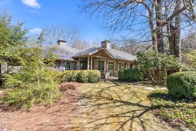 view of front of house with a chimney and a front yard