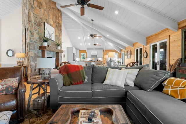 bedroom featuring a tray ceiling, a fireplace, light wood-type flooring, and baseboards